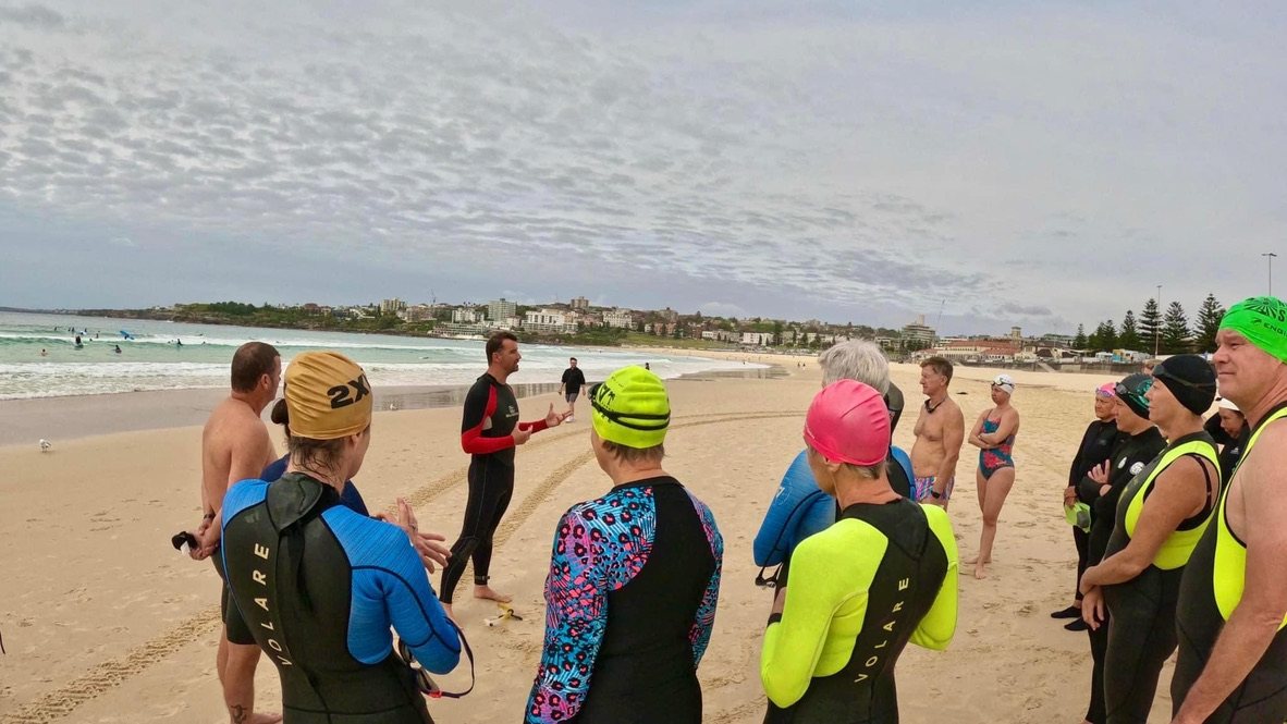 Jason Cram briefing a group before an ocean swim