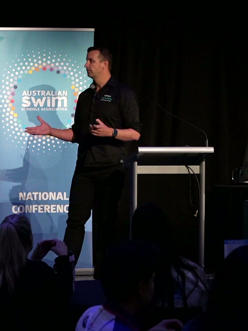 Jason Cram speaking on stage at the Australian Swim Schools Association National Conference